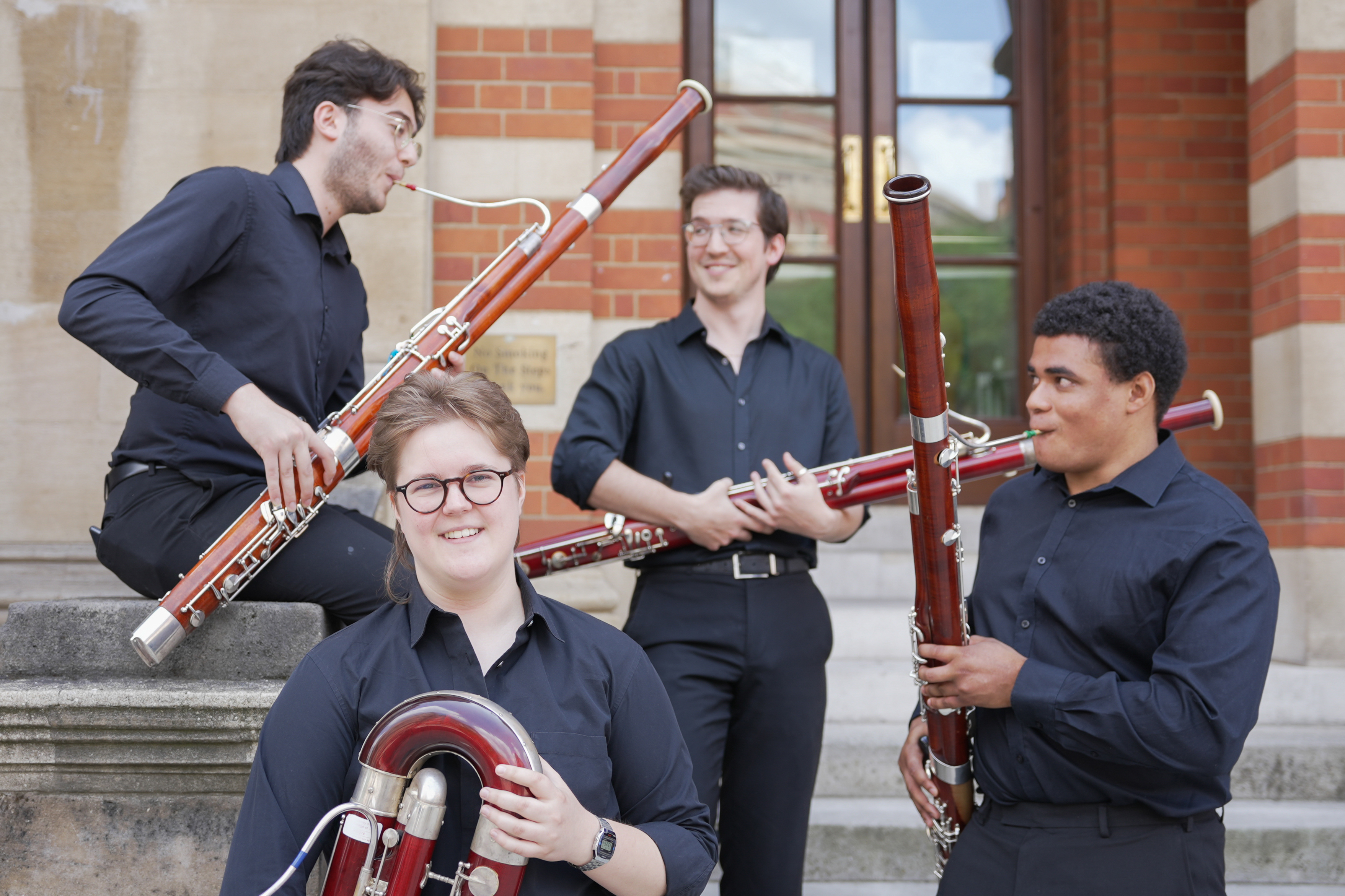 Four RCM bassoonists on the steps of the Royal College of Music 
